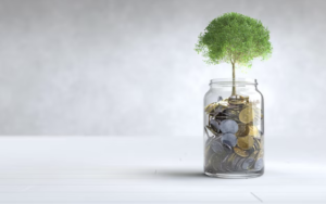 . A money tree in a jar surrounded by coins, with additional coins scattered on the table, symbolizing savings and prosperity - consumer behavior